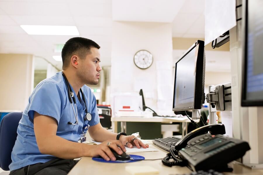medical professional working on a computer