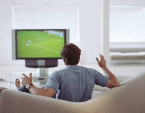 man watching football game on streaming service