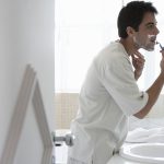 National Men’s Grooming Brand Earned $3.03 for Every $1 Invested with Valpak Man shaving at a bathroom mirror with a razor and shaving cream
