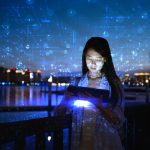 At night, a woman talks to artificial intelligence